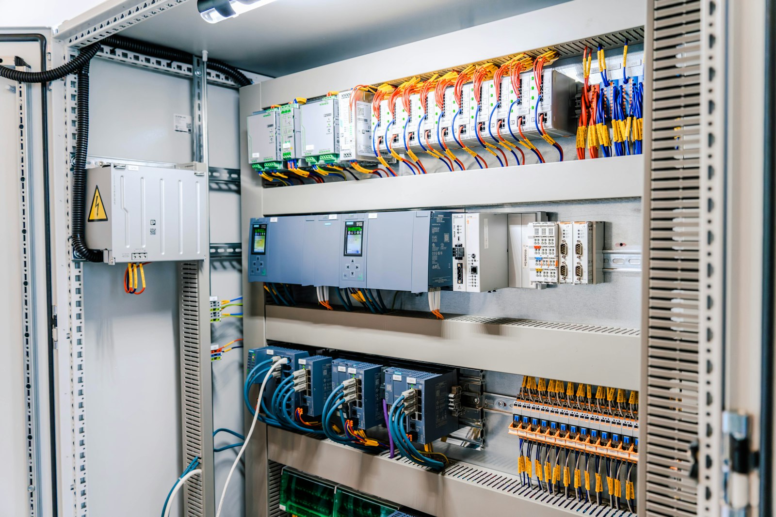 A building management control panel with its modules and wiring.